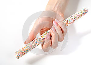 Beautiful hand with perfect manicure, sweet candy