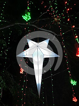 Beautiful handmade Christmas star hanging on tree