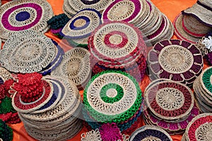 Beautiful handmade coasters and doormats made by jute is displayed in a shop for sale in blurred background. Indian handicraft