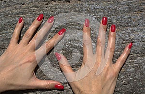 Beautiful hands on the rocks of a volcano