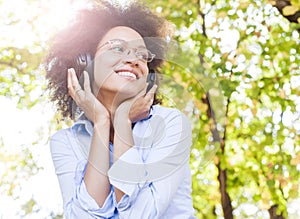 Beautiful Happy Afro American Young Woman Listening Music In Nature