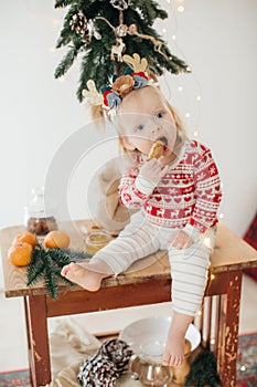 Beautiful happy  baby girl  near Christmas tree