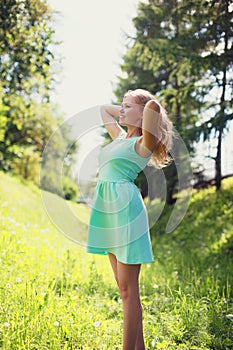 Beautiful happy blonde woman in dress outdoors