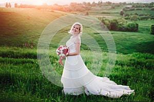 Beautiful happy blonde woman in white dress smiling in sun light . Glow sun.