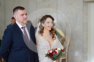 beautiful and happy bride and groom in the registry office