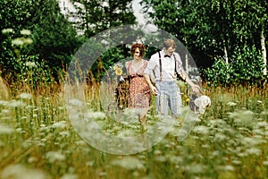 beautiful happy bride and stylish retro groom with basket holding hands, picnic time