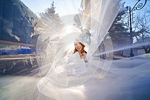 beautiful and happy bride under a white veil.