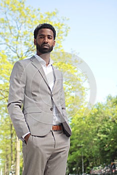 Beautiful happy business man outside in the park