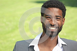 Beautiful happy business man outside in the park