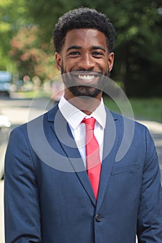 Beautiful happy business man outside in the park