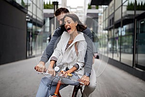 Beautiful happy couple in love on bicycle in the city