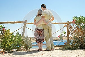 Beautiful happy couple on nature sea background