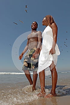 Beautiful Happy Couple Walking Along the Beach