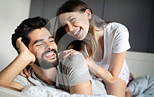 Beautiful happy couple of young lovers are hugging indoors at home, with love and tenderness