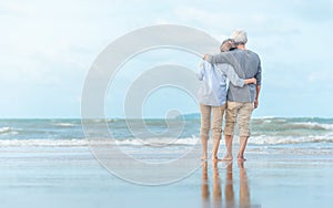 Beautiful happy elderly couple rest at tropical resort,back view