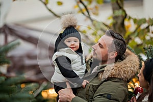 Beautiful happy family at the Christmas market. Winter holiday. Holidays in Europe. New Year