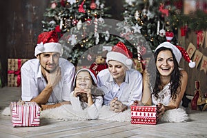 Beautiful happy family mother, father, son, and daughter to celebrate Christmas and new year together at home