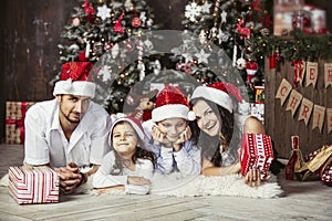 Beautiful happy family mother, father, son, and daughter to celebrate Christmas and new year together at home