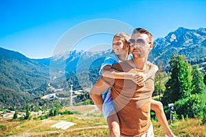 Beautiful happy family in mountains in the background