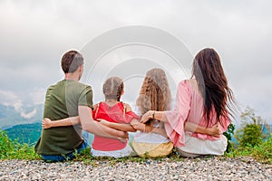 Beautiful happy family in mountains in the background of fog