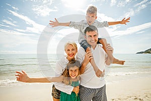 beautiful happy family on vacation standing together in front photo