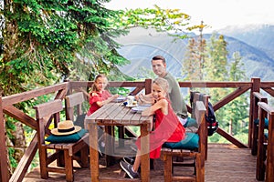 Beautiful happy father with kids in mountains in the background of fog