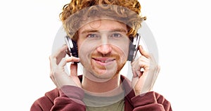 Beautiful happy fun young adult redhead man listening to music using headphones and dancing.Person action.People video