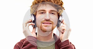 Beautiful happy fun young adult redhead man listening to music using headphones and dancing.Person action.People video