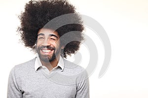 Beautiful happy funky afro man posing in front of a background