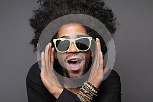 Beautiful happy funky afro man posing in front of a background