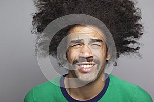 Beautiful happy funky afro man posing in front of a background