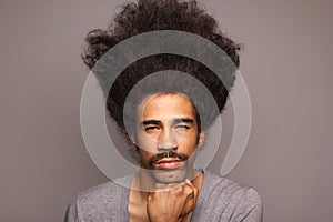 Beautiful happy funky afro man posing in front of a background