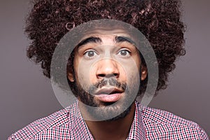 Beautiful happy funky afro man posing in front of a background