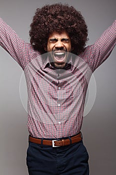 Beautiful happy funky afro man posing in front of a background