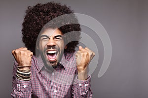 Beautiful happy funky afro man posing in front of a background