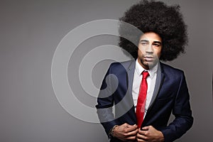 Beautiful happy funky afro man posing in front of a background