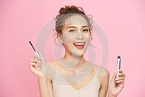 Beautiful happy girl apply mascara facial cosmetics photo
