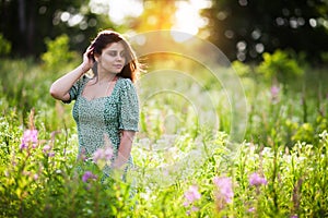 Beautiful happy girl among the field