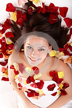 Beautiful happy girl in rose petal. Spa .