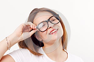 Beautiful happy girl teenager in glasses smiles