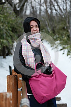 Beautiful and happy girl in winter snowy day outdoors