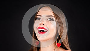 Beautiful happy girl. Young smiling woman with make up in black studio. Fashion portrait of female model with red lips.