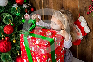 Beautiful happy Girlie opens New Year`s gift