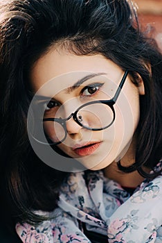 Beautiful happy hipster girl goes in the city. Closeup of trendy girl face.