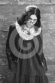 Beautiful happy hipster girl goes in the city. Closeup of trendy girl face.