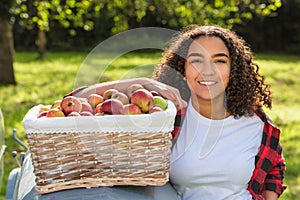 Mixed Race Female Teenager Leaning on Tractor Picking Apples