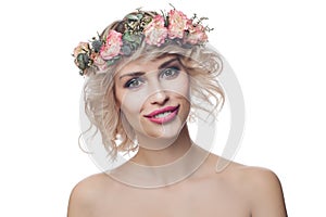 Beautiful happy model woman wearing flowers crown isolated on white background. Curly Hair, Makeup and Flowers
