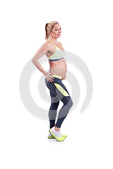 Beautiful happy pregnant women doing exercise with kettlebell on the white background