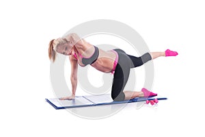 Beautiful happy pregnant women doing exercise with mat on the white background