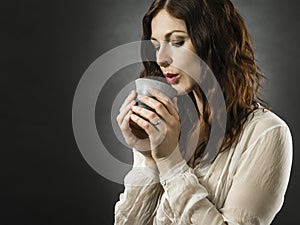 Beautiful happy redhead woman drinking coffee